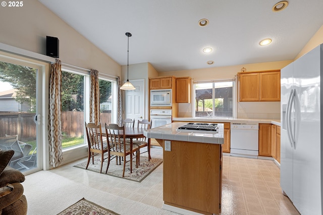 1545 NE Gertz Rd, Portland, OR 97211 - kitchen with white appliances, vaulted ceiling, tile countertops, a kitchen island, and light floors