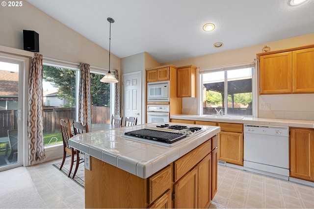 1545 NE Gertz Rd, Portland, OR 97211 - kitchen featuring white appliances, tile countertops, lofted ceiling, a sink, and light floors