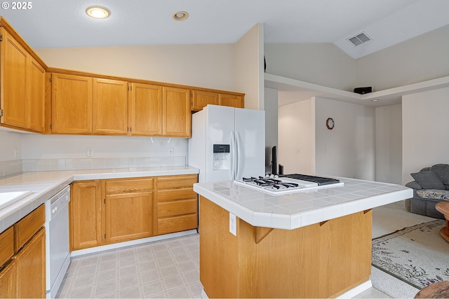 1545 NE Gertz Rd, Portland, OR 97211 - kitchen with white appliances, tile countertops, high vaulted ceiling, open floor plan, and a kitchen island