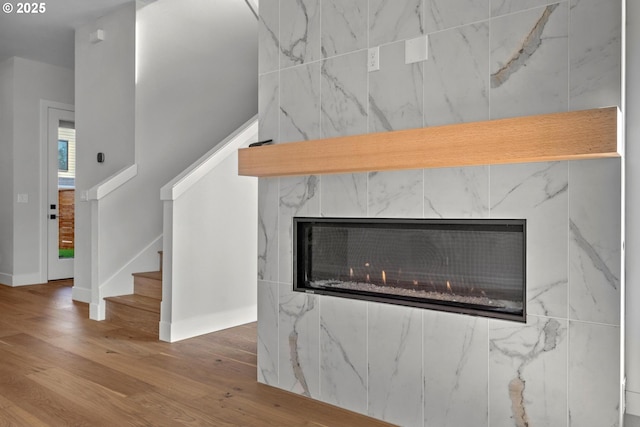 room details featuring hardwood / wood-style flooring and a tile fireplace