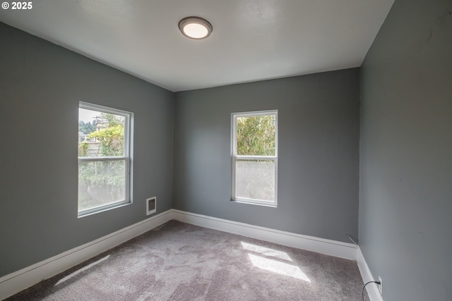 640 8th St, Astoria, OR 97103 - empty room featuring carpet, baseboards, visible vents, and plenty of natural light