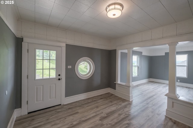 640 8th St, Astoria, OR 97103 - entrance foyer with baseboards, ornate columns, and wood finished floors