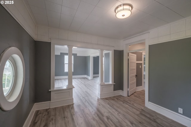 640 8th St, Astoria, OR 97103 - entrance foyer with baseboards, crown molding, ornate columns, and wood finished floors