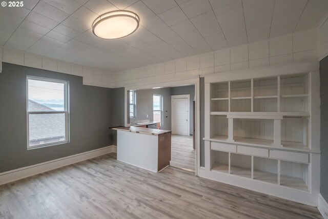 640 8th St, Astoria, OR 97103 - interior space featuring a peninsula, baseboards, and wood finished floors