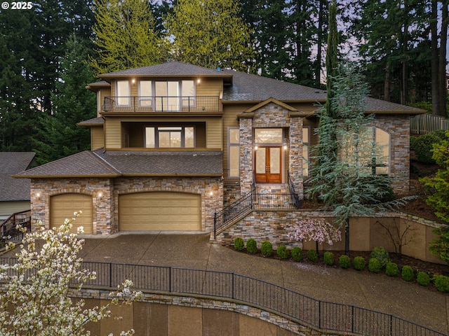 14079 SE Alta Vista Dr, Happy Valley, OR 97086 - prairie-style house with a shingled roof, an attached garage, stone siding, a balcony, and driveway