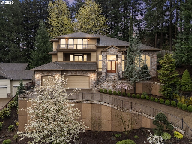 14079 SE Alta Vista Dr, Happy Valley, OR 97086 - prairie-style home with roof with shingles, a balcony, stone siding, a fenced front yard, and a garage