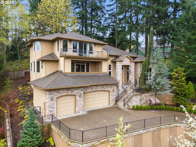 14079 SE Alta Vista Dr, Happy Valley, OR 97086 - prairie-style house featuring a balcony, driveway, a garage, fence, and a shingled roof