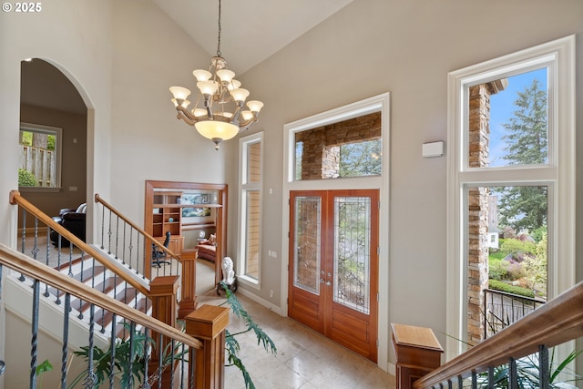 14079 SE Alta Vista Dr, Happy Valley, OR 97086 - foyer entrance with high vaulted ceiling, light tile patterned floors, arched walkways, baseboards, and a notable chandelier