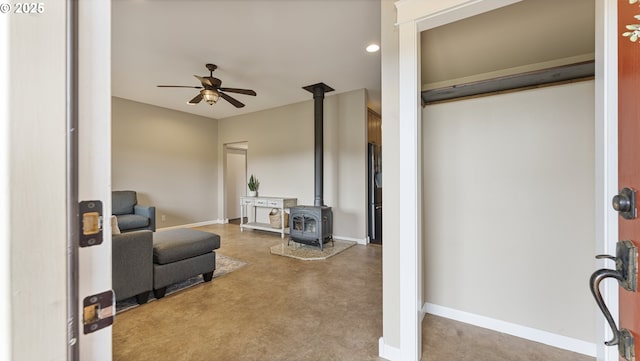 87951 Blazer Ln, Bandon, OR 97411 - living area with a wood stove, a ceiling fan, concrete floors, and recessed lighting