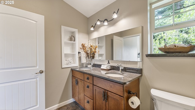 87951 Blazer Ln, Bandon, OR 97411 - bathroom with double vanity, lofted ceiling, and built in shelves