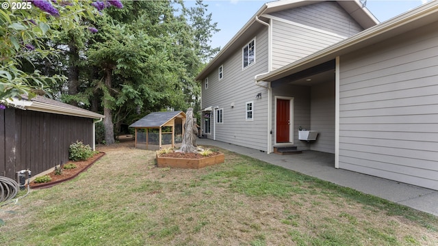 87951 Blazer Ln, Bandon, OR 97411 - view of green lawn with an outdoor structure and a patio area