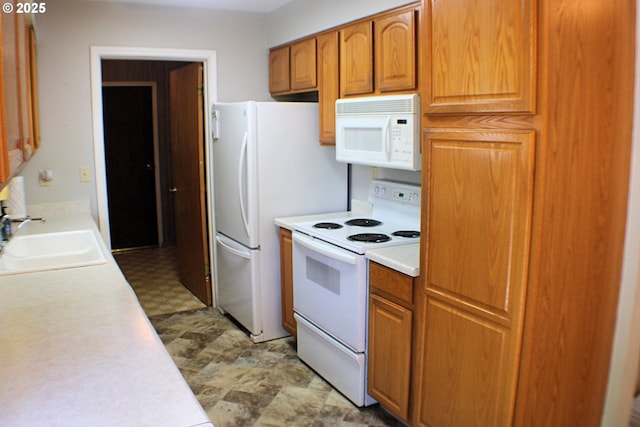131 Mountain View Ave, Myrtle Creek, OR 97457 - kitchen with white appliances, light countertops, light flooring, and brown cabinetry