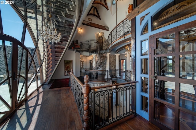26480 SW Wilken Ln, West Linn, OR 97068 - foyer entrance featuring ornate columns, wood finished floors, a chandelier, a towering ceiling, and healthy amount of natural light