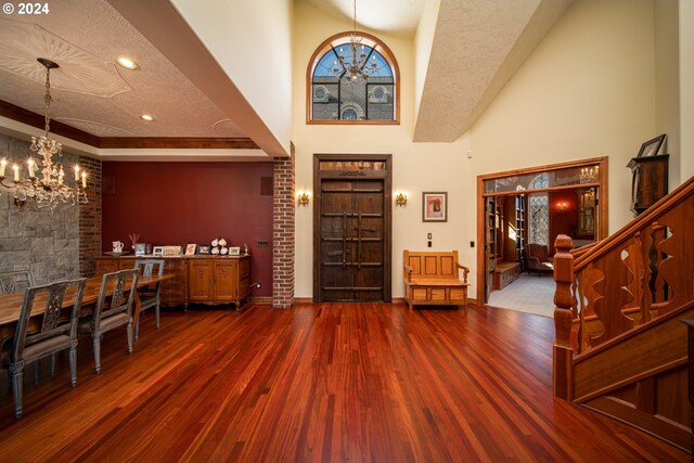 26480 SW Wilken Ln, West Linn, OR 97068 - foyer featuring a chandelier, wood finished floors, baseboards, a high ceiling, and stairway