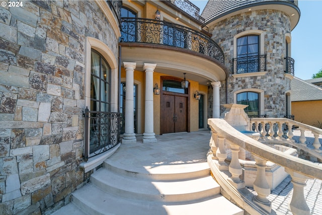 26480 SW Wilken Ln, West Linn, OR 97068 - doorway to property featuring a balcony, stone siding, and a high end roof