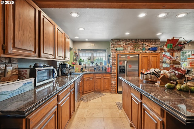 kitchen featuring tasteful backsplash, stainless steel fridge, sink, and light tile patterned floors