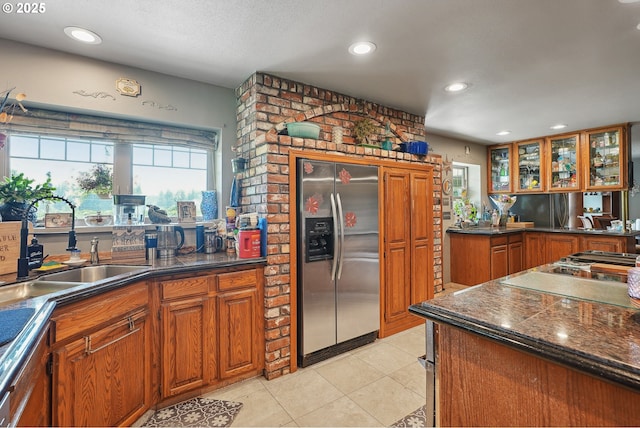 kitchen featuring light tile patterned flooring, sink, and stainless steel appliances