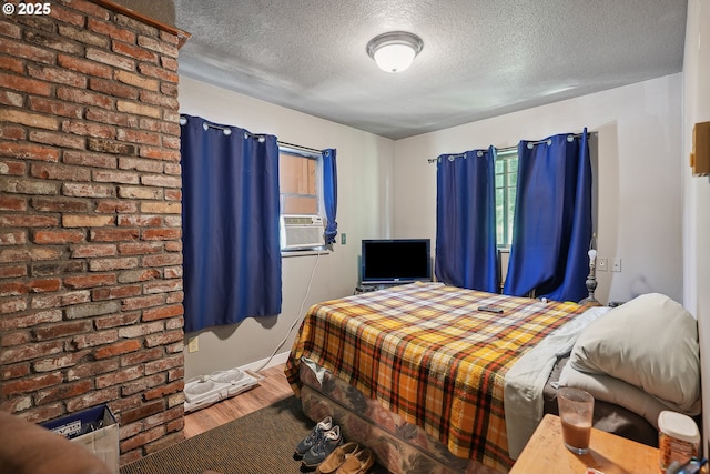 bedroom with wood-type flooring and a textured ceiling