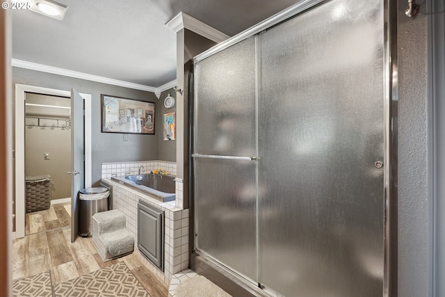 bathroom with sink, ornamental molding, shower with separate bathtub, and hardwood / wood-style flooring