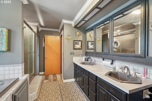 bathroom with vanity, a bathtub, and ornamental molding