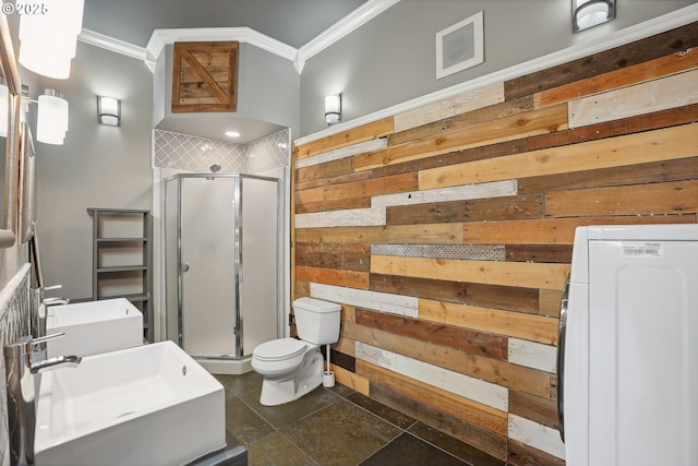 bathroom featuring wood walls, sink, crown molding, walk in shower, and washer / clothes dryer