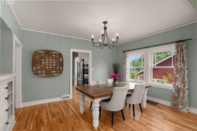 224 NE 44th Ave, Portland, OR 97213 - dining room featuring a chandelier, ornamental molding, baseboards, and light wood-type flooring