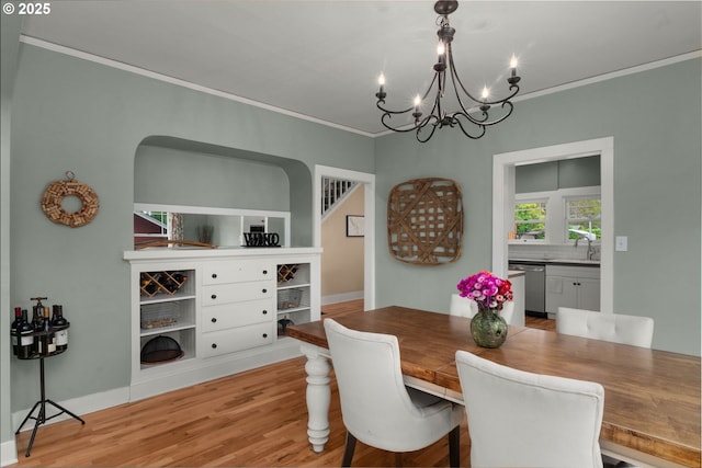 224 NE 44th Ave, Portland, OR 97213 - dining room featuring a chandelier, ornamental molding, light wood-style floors, and baseboards