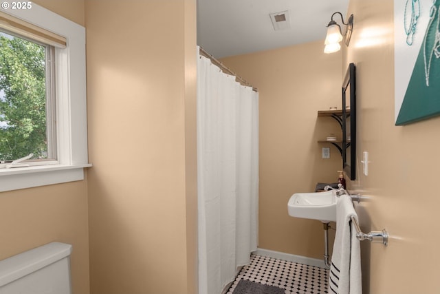 224 NE 44th Ave, Portland, OR 97213 - bathroom featuring toilet, tile patterned floors, a shower with shower curtain, and baseboards