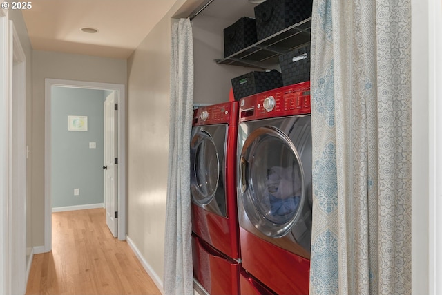 224 NE 44th Ave, Portland, OR 97213 - laundry area with wood finished floors, baseboards, and washing machine and dryer