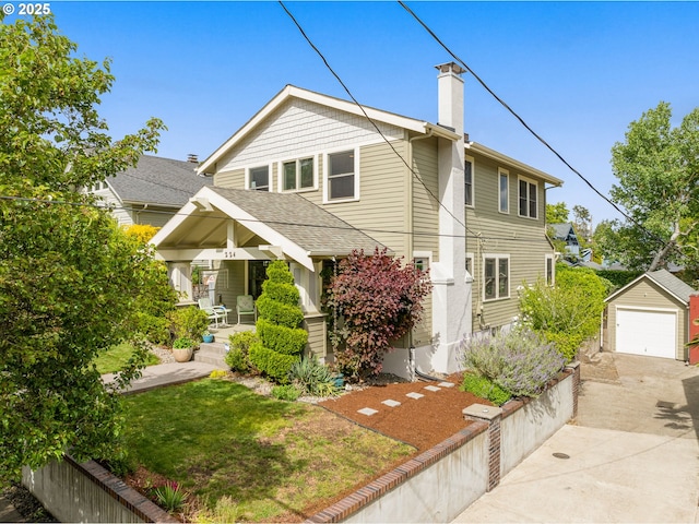 224 NE 44th Ave, Portland, OR 97213 - view of front facade featuring covered porch, an outdoor structure, a chimney, concrete driveway, and a detached garage