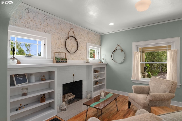 224 NE 44th Ave, Portland, OR 97213 - living room featuring wood finished floors, a fireplace, baseboards, and crown molding