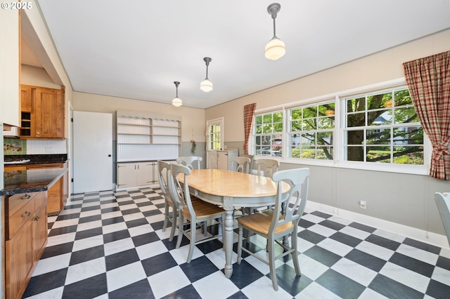 dining area with baseboards and light floors