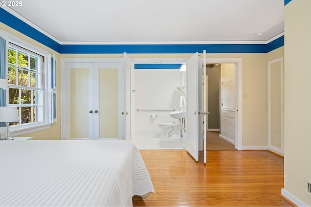bedroom featuring baseboards and light wood finished floors