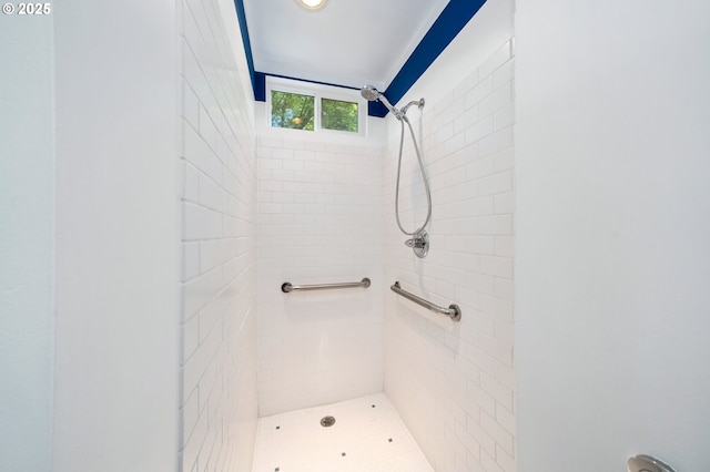 bathroom with a tile shower