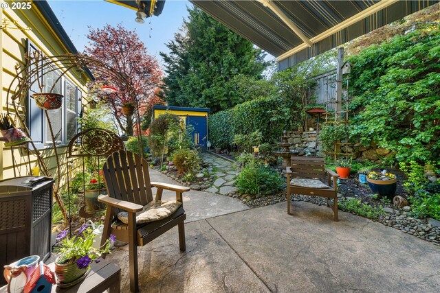 view of patio with an outdoor structure and a fenced backyard