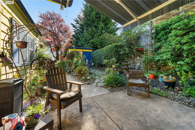 view of patio with a fenced backyard and an outbuilding