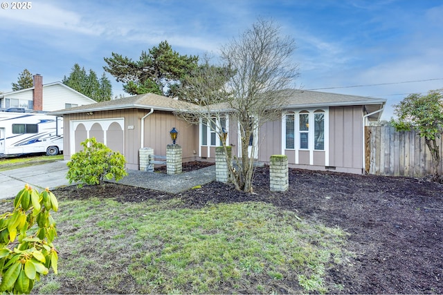 view of front of property with a garage and a front lawn