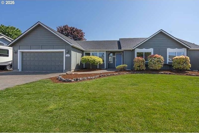 single story home with driveway, a front yard, and a garage