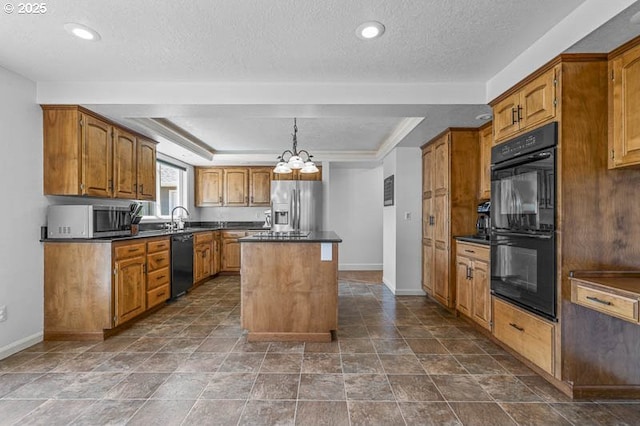 kitchen with dark countertops, a raised ceiling, a center island, and black appliances