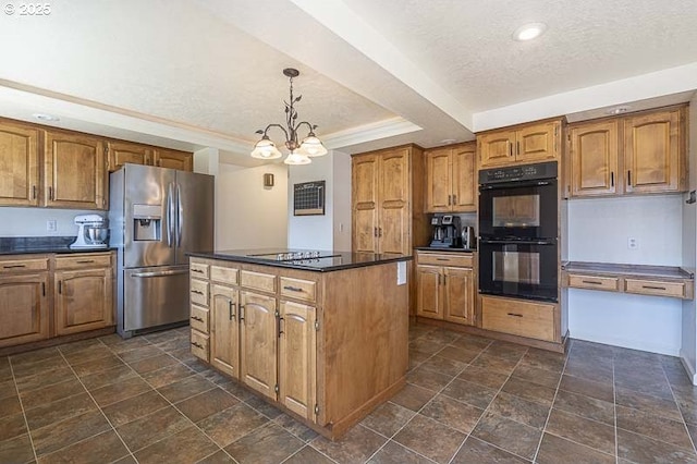 kitchen with a kitchen island, black appliances, dark countertops, and brown cabinets