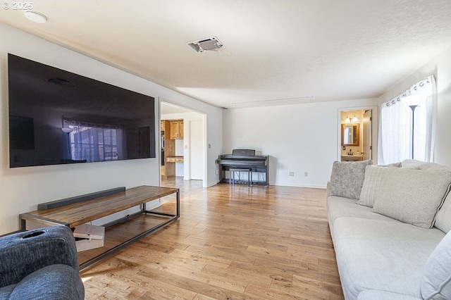 living area with light wood finished floors and visible vents