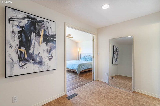 carpeted bedroom featuring baseboards and visible vents