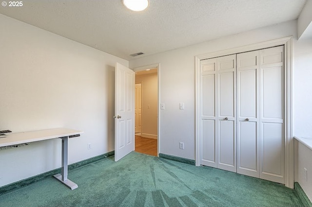 unfurnished bedroom featuring carpet floors, baseboards, a closet, and visible vents
