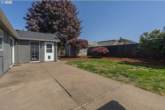 view of yard featuring a patio and fence