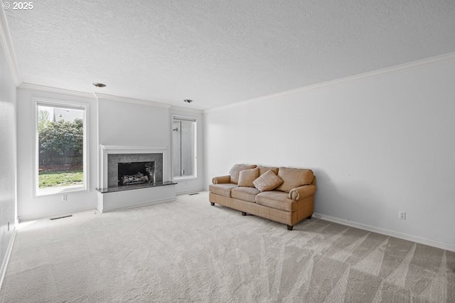 carpeted living area featuring crown molding, a textured ceiling, baseboards, and a fireplace