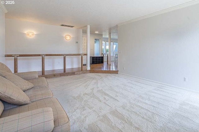 unfurnished living room with carpet floors, crown molding, visible vents, and baseboards
