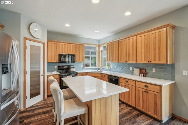812 NW 13th Ave, Battle Ground, WA 98604 - kitchen with black appliances, dark wood-style flooring, tasteful backsplash, and recessed lighting