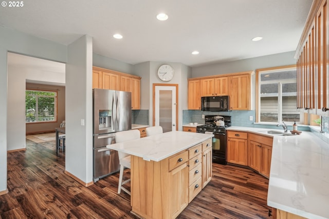 812 NW 13th Ave, Battle Ground, WA 98604 - kitchen featuring black appliances, a sink, dark wood finished floors, decorative backsplash, and a kitchen island