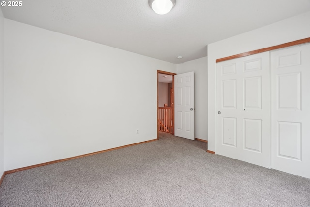 812 NW 13th Ave, Battle Ground, WA 98604 - unfurnished bedroom featuring carpet, a closet, and baseboards