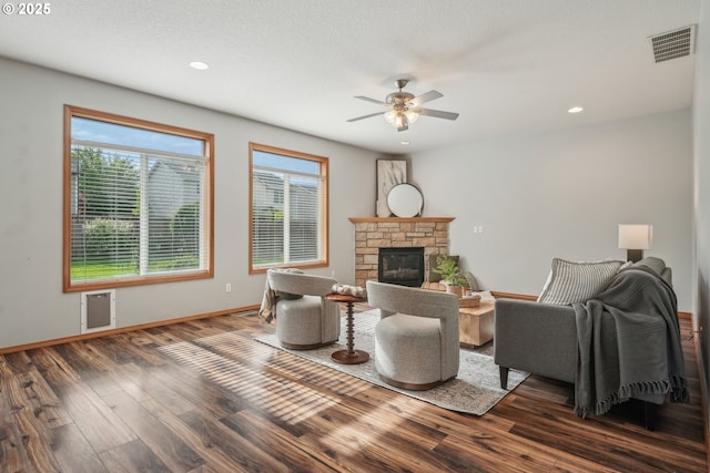 812 NW 13th Ave, Battle Ground, WA 98604 - living room featuring dark wood finished floors, a ceiling fan, a stone fireplace, baseboards, and recessed lighting